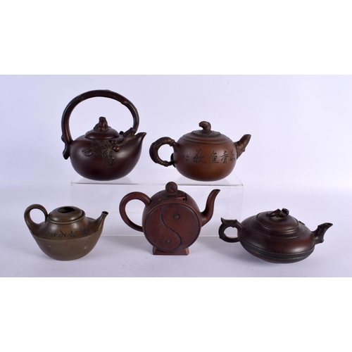 2076 - FIVE CHINESE YIXING POTTERY TEAPOT AND COVERS. Largest 15 cm wide. (5)