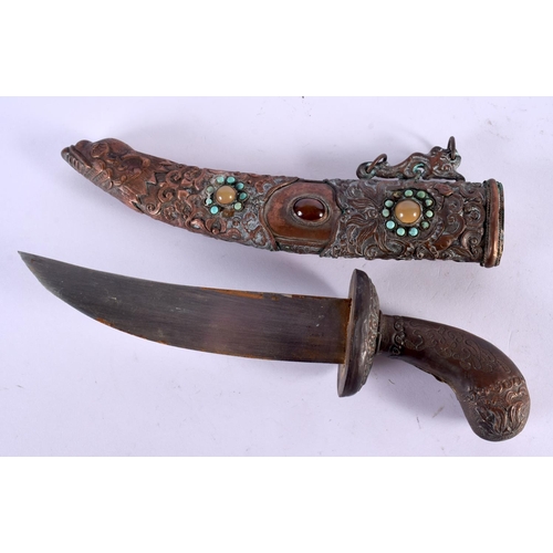 2090 - AN EARLY 20TH CENTURY CHINESE TIBETAN JEWELLED COPPER DAGGER decorated with foliage. 32 cm long.