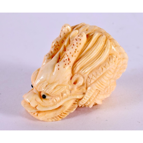 2160 - A JAPANESE BONE DRAGON RING. 3 cm x 2 cm.