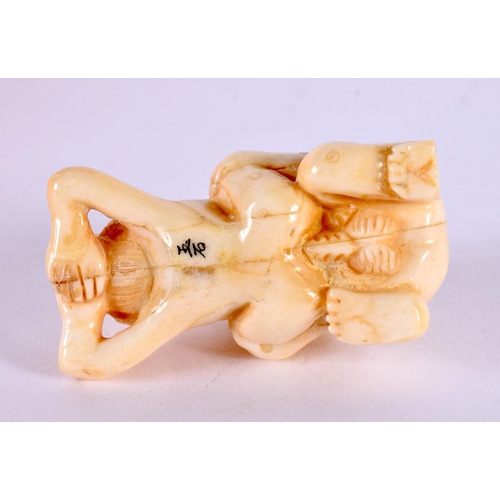 2164 - A JAPANESE CARVED BONE EROTIC OKIMONO. 5 cm x 3 cm.