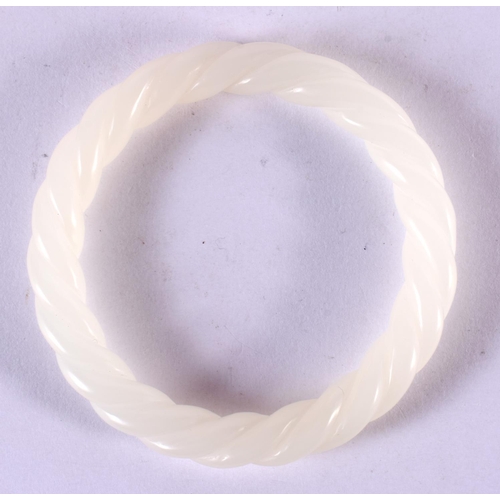 2175 - A CHINESE WHITE JADE TWIST BANGLE 20th Century. 8 cm diameter.