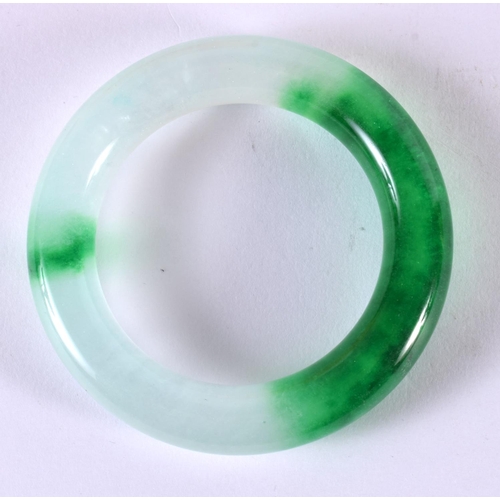 2182 - A CHINESE CARVED JADEITE BANGLE 20th Century. 8 cm diameter.