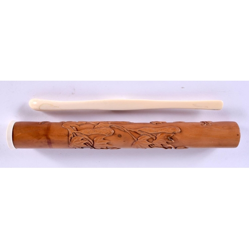 2198 - A JAPANESE TAISHO PERIOD BOXWOOD CYLINDRICAL POT containing a bone spoon. 23 cm long. (2)