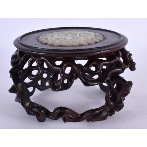 2218 - A CHINESE CARVED HARDWOOD STAND 20th Century, inset with a jade roundel. 12 cm x 8 cm.