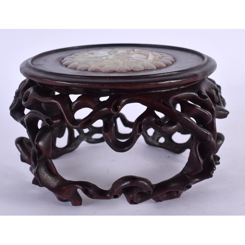 2218 - A CHINESE CARVED HARDWOOD STAND 20th Century, inset with a jade roundel. 12 cm x 8 cm.