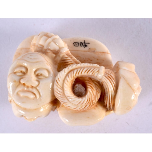 2228 - A JAPANESE CARVED BONE MASK NETSUKE. 5 cm x 3 cm.