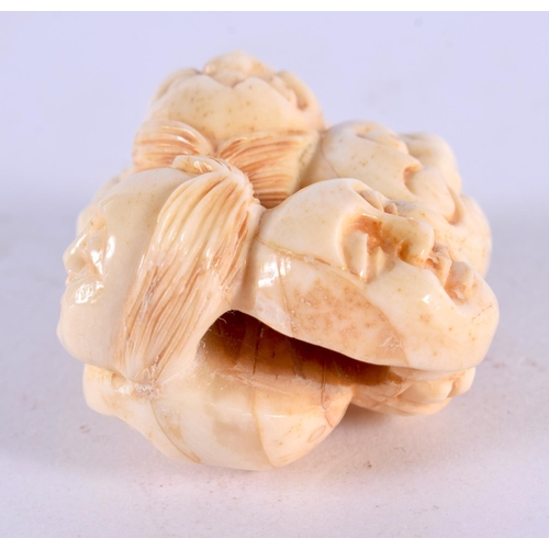 2228 - A JAPANESE CARVED BONE MASK NETSUKE. 5 cm x 3 cm.