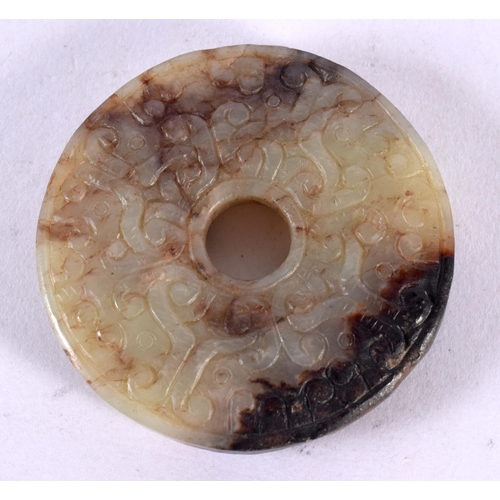 2307 - A 19TH CENTURY CHINESE CARVED TWO TONE JADE ROUNDEL Qing. 5 cm diameter.