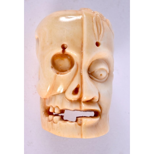 2317 - A JAPANESE CARVED BONE ANATOMICAL SKULL MASK. 5 cm x 3 cm.