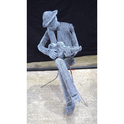 3494 - A twisted wire sculpture of a seated man playing a ukulele 92 cm .