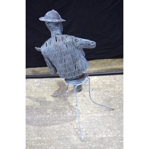 3494 - A twisted wire sculpture of a seated man playing a ukulele 92 cm .