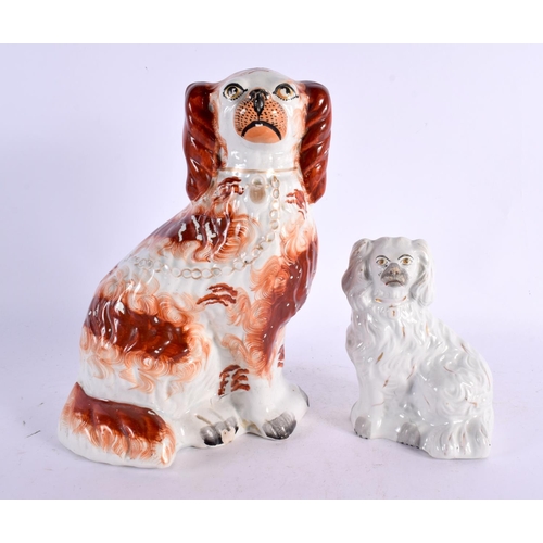 11 - FOUR 19TH CENTURY STAFFORDSHIRE FIGURES including a large spaniel. Largest 28 cm x 15 cm. (4)