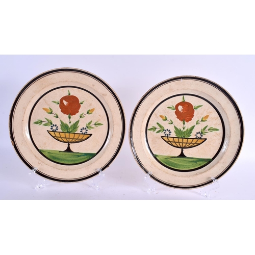 110 - A PAIR OF 19TH CENTURY CREAMWARE PAINTED PLATES together with a faience mug. Largest 21.5 cm diamete... 