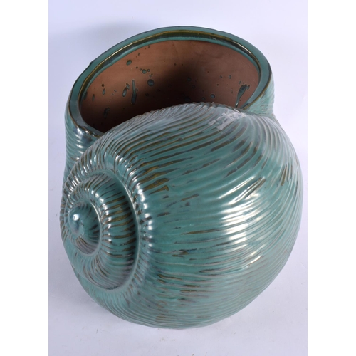 12 - A LARGE AND UNUSUAL GREEN GLAZED POTTERY NAUTILLUS SHELL PLANTER of naturalistic form. 40 cm x 27 cm... 