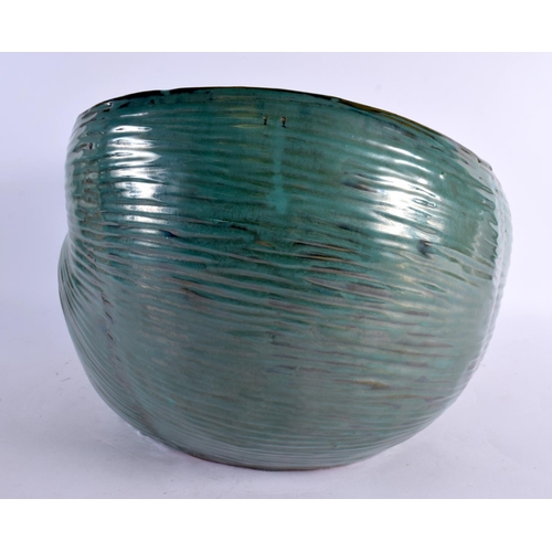 12 - A LARGE AND UNUSUAL GREEN GLAZED POTTERY NAUTILLUS SHELL PLANTER of naturalistic form. 40 cm x 27 cm... 