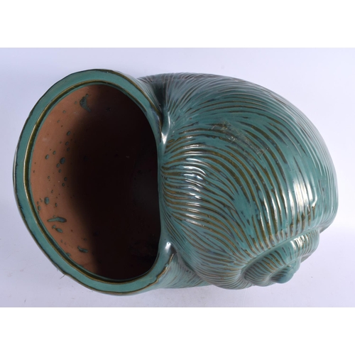 12 - A LARGE AND UNUSUAL GREEN GLAZED POTTERY NAUTILLUS SHELL PLANTER of naturalistic form. 40 cm x 27 cm... 