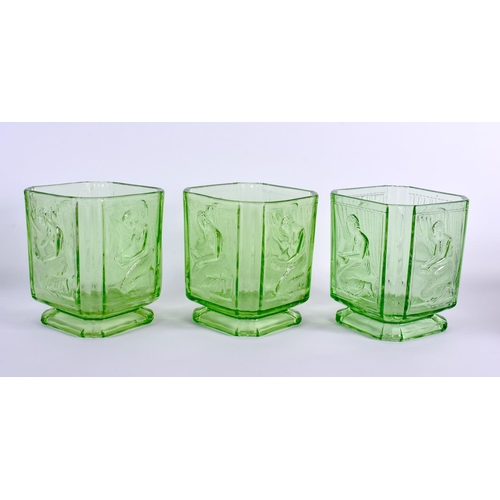 124 - A SET OF THREE GREEN BAGLEY GLASS 'PANDORA BOX' SWEET JARS formed with kneeling females. 15 cm x 10 ... 