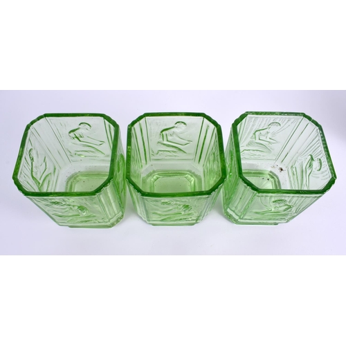 124 - A SET OF THREE GREEN BAGLEY GLASS 'PANDORA BOX' SWEET JARS formed with kneeling females. 15 cm x 10 ... 