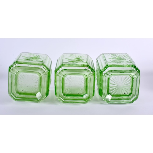 124 - A SET OF THREE GREEN BAGLEY GLASS 'PANDORA BOX' SWEET JARS formed with kneeling females. 15 cm x 10 ... 