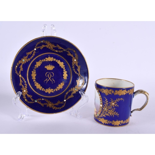 145 - A 19TH CENTURY SEVRES PORCELAIN CABINET CUP AND SAUCER jewelled with turquoise. 12 cm diameter. (2)