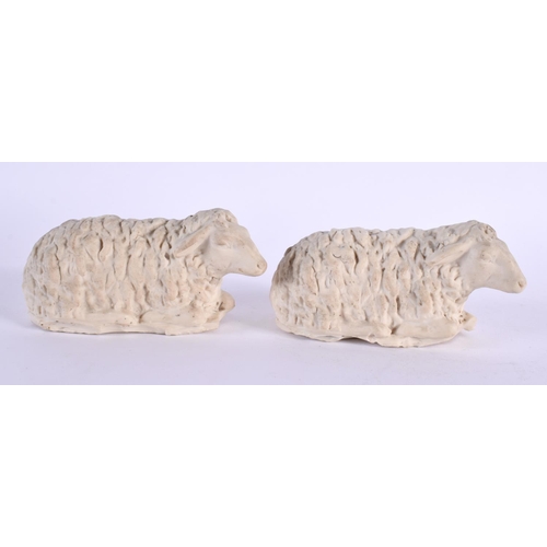 152 - A PAIR OF 19TH CENTURY ENGLISH PARIAN WARE PORCELAIN FIGURES OF SHEEP modelled recumbant. 10 cm wide... 