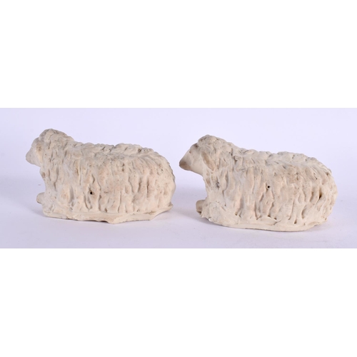 152 - A PAIR OF 19TH CENTURY ENGLISH PARIAN WARE PORCELAIN FIGURES OF SHEEP modelled recumbant. 10 cm wide... 