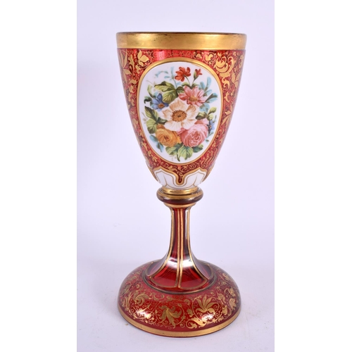 163 - A 19TH CENTURY BOHEMIAN RUBY AND GILDED GLASS GOBLET overlaid with white enamelled flowers, in the m... 