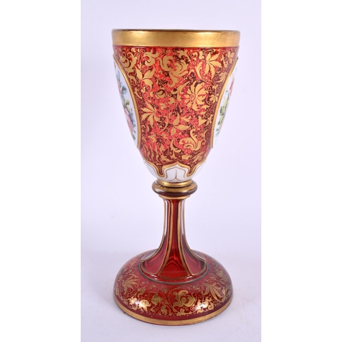 163 - A 19TH CENTURY BOHEMIAN RUBY AND GILDED GLASS GOBLET overlaid with white enamelled flowers, in the m... 