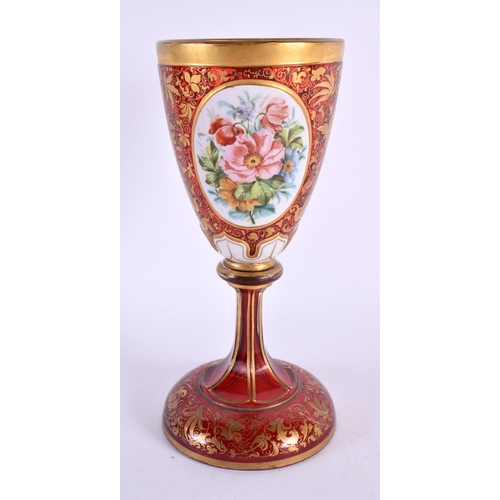 163 - A 19TH CENTURY BOHEMIAN RUBY AND GILDED GLASS GOBLET overlaid with white enamelled flowers, in the m... 