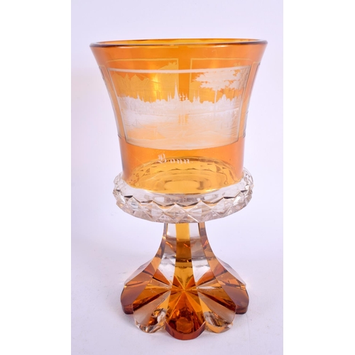 178 - AN ANTIQUE BOHEMIAN AMBER AND CLEAR GLASS BEAKER VASE engraved with various scenes. 18 cm x 10 cm.