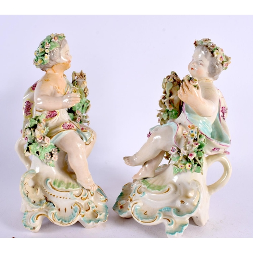 189 - A PAIR OF 18TH CENTURY DERBY PORCELAIN FIGURES OF PUTTI modelled seated upon floral encrusted seats.... 