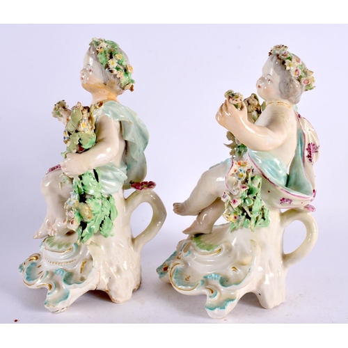 189 - A PAIR OF 18TH CENTURY DERBY PORCELAIN FIGURES OF PUTTI modelled seated upon floral encrusted seats.... 