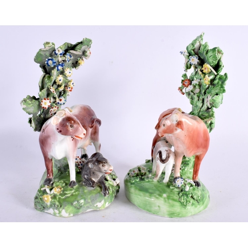 212 - 18th century pair of Derby cow groups standing before a brocage. 15cm high. (2)