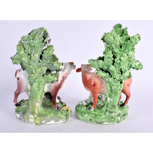 212 - 18th century pair of Derby cow groups standing before a brocage. 15cm high. (2)