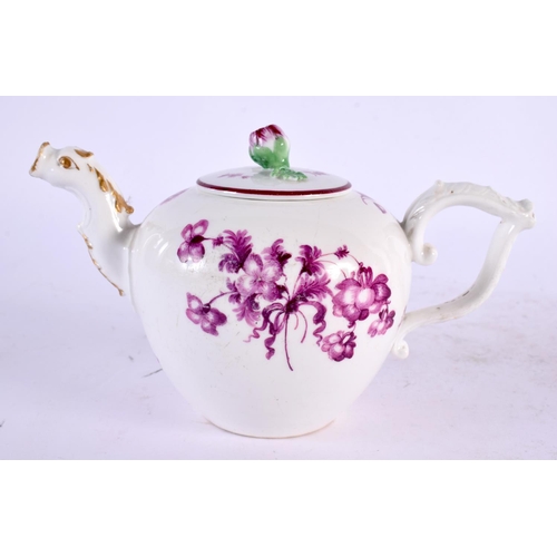 22 - AN 18TH CENTURY GERMAN PORCELAIN TEAPOT AND COVER painted with puce flowers. 17 cm wide.