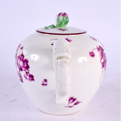 22 - AN 18TH CENTURY GERMAN PORCELAIN TEAPOT AND COVER painted with puce flowers. 17 cm wide.