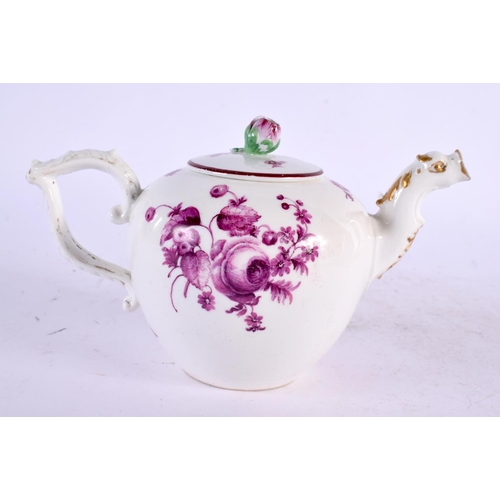 22 - AN 18TH CENTURY GERMAN PORCELAIN TEAPOT AND COVER painted with puce flowers. 17 cm wide.