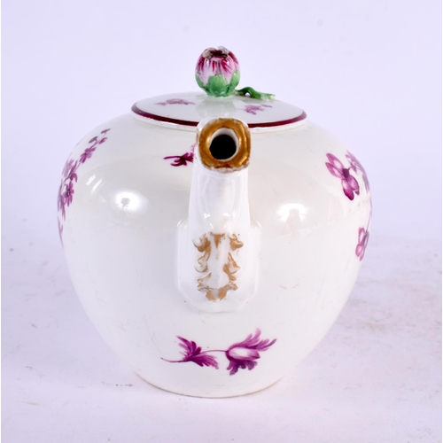 22 - AN 18TH CENTURY GERMAN PORCELAIN TEAPOT AND COVER painted with puce flowers. 17 cm wide.