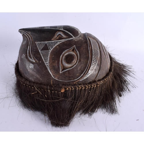 311 - AN UNUSUAL TRIBAL CARVED WOOD BIRD FORM MASK with geomteric carvings. 30 cm x 30 cm.