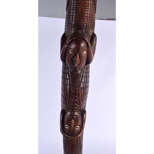 321 - A LARGE SOUTHSEA ISLANDS TRIBAL POLYNESIAN CARVED WOOD CROCODILE modelled as a kayman clutching shel... 