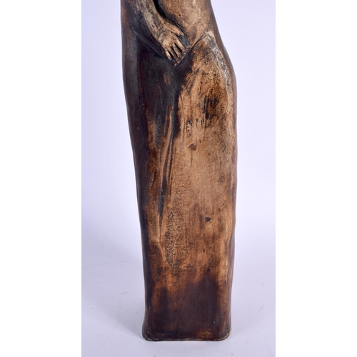 371 - A LARGE VINTAGE POTTERY FIGURE OF A STYLISED FEMALE of slender form. 63 cm high.