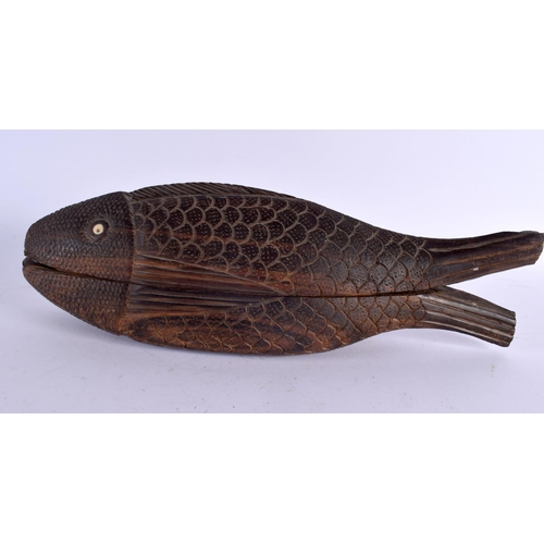 374 - A TRIBAL CARVED HARDWOOD FISH BOX AND COVER with bone eyes. 35 cm wide.