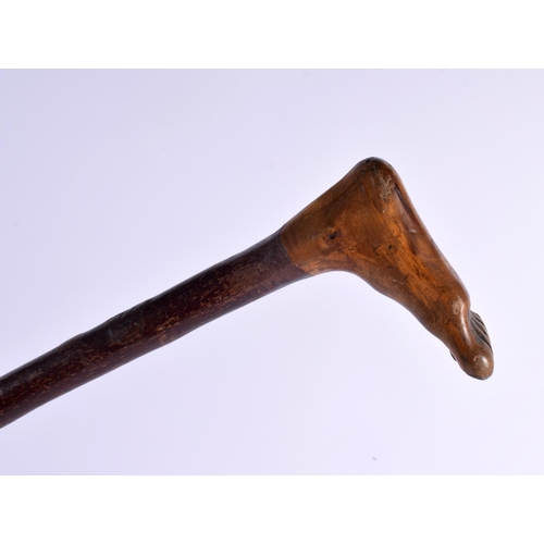 381 - AN ANTIQUE CARVED FOLK ART FOOT WALKING CANE. 90 cm long.