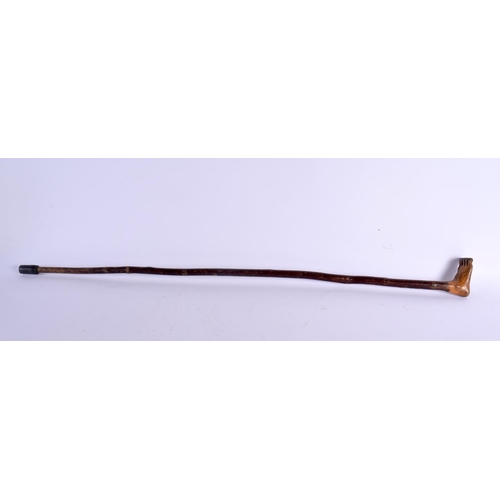 381 - AN ANTIQUE CARVED FOLK ART FOOT WALKING CANE. 90 cm long.