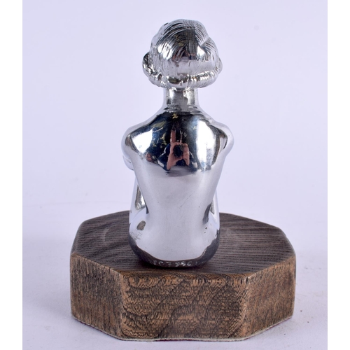 404 - AN ART DECO CHROME CAR MASCOT formed as a seated female clutching her legs. 14 cm x 9 cm.