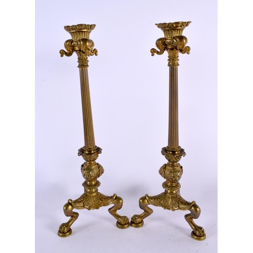 412 - A PAIR OF MID 19TH CENTURY FRENCH BRONZE CANDLESTICKS formed with lion and elephant mask heads. 35 c... 