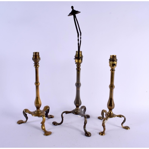 415 - THREE ART NOUVEAU BRASS COUNTRY HOUSE LAMPS in the manner of W A S Benson. Largest 47 cm high. (3)