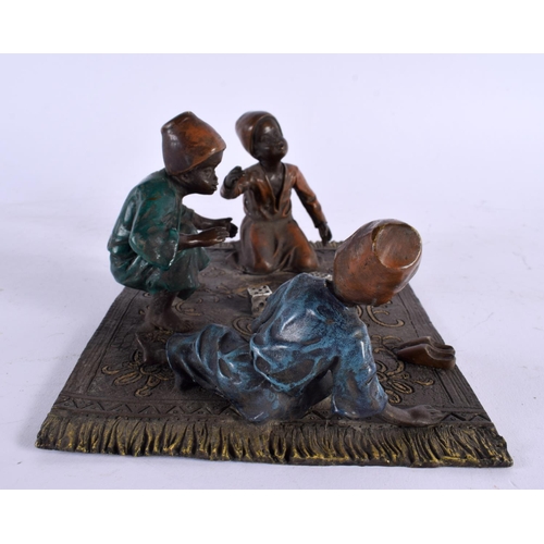 423 - A CONTEMPORARY COLD PAINTED BRONZE FIGURAL GROUP depicting children playing dice. 20 cm x 14 cm.