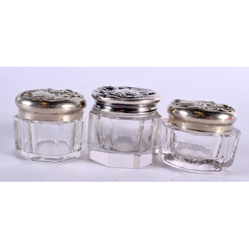 438 - FIVE SILVER TOPPED DRESSING TABLE JARS. Largest 4 cm x 3 cm. (5)