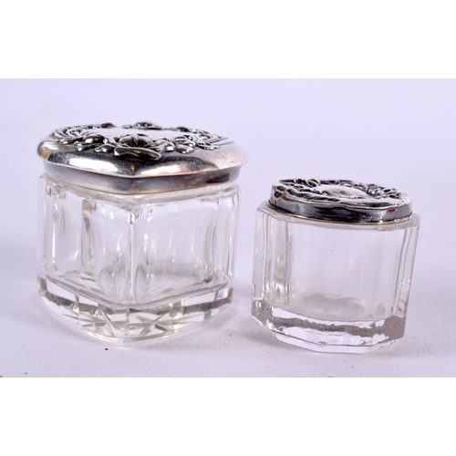 438 - FIVE SILVER TOPPED DRESSING TABLE JARS. Largest 4 cm x 3 cm. (5)